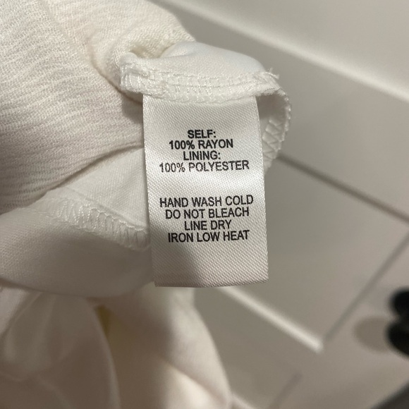 Embroidered white v neck sundress with open back and back bow tie detail - Picture 10 of 10